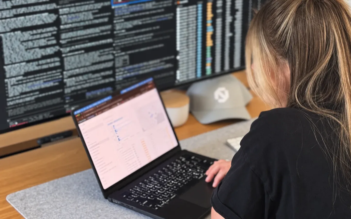 A Bidlo teammate at a desk, working through a report on a laptop